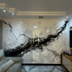 Large marble-effect wall panels with black and gold veining in a modern living room setting.